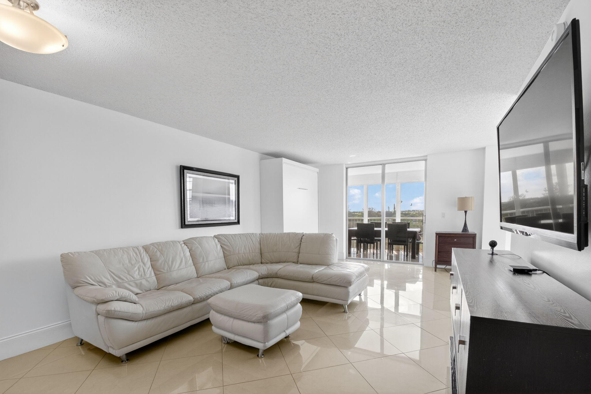 5500 Northwest 2nd Avenue, Unit 718 Boca Raton, FL 33487 - Photo 12 of 34 a living room with furniture and a flat screen tv