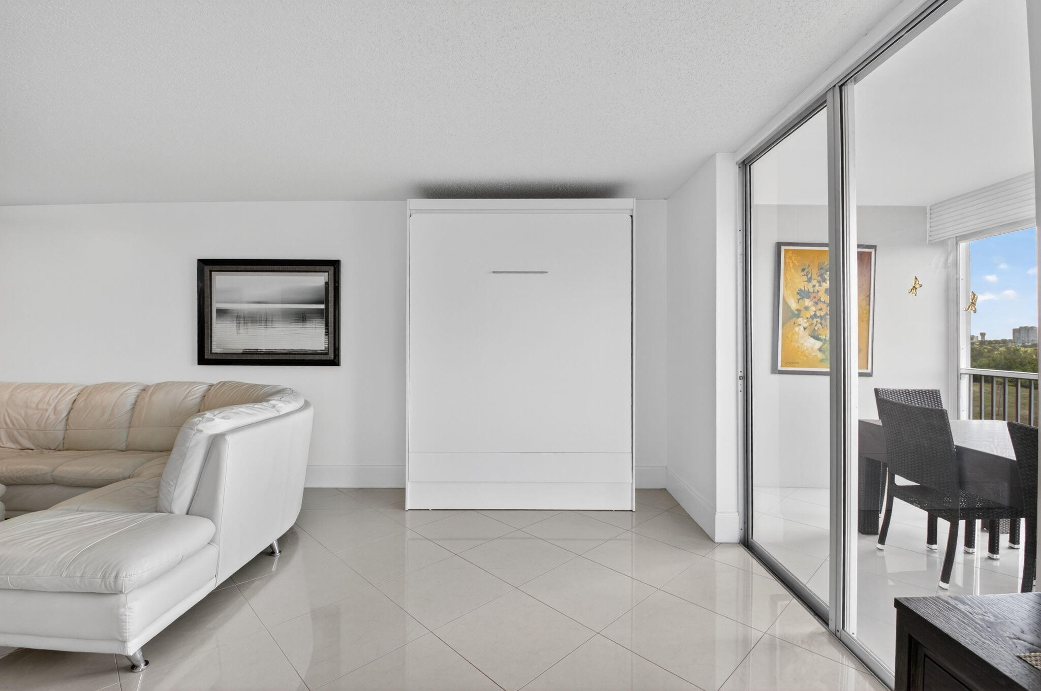 5500 Northwest 2nd Avenue, Unit 718 Boca Raton, FL 33487 - Photo 16 of 34 a living room with furniture and a dining table