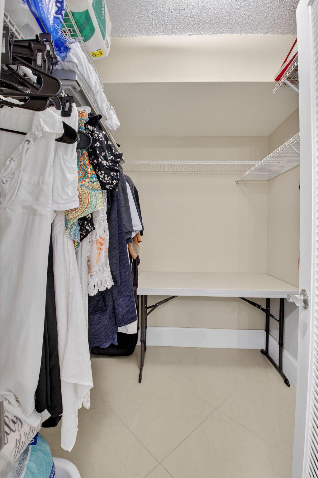 5500 Northwest 2nd Avenue, Unit 718 Boca Raton, FL 33487 - Photo 24 of 34 a view of walk in closet with clothes and shoes