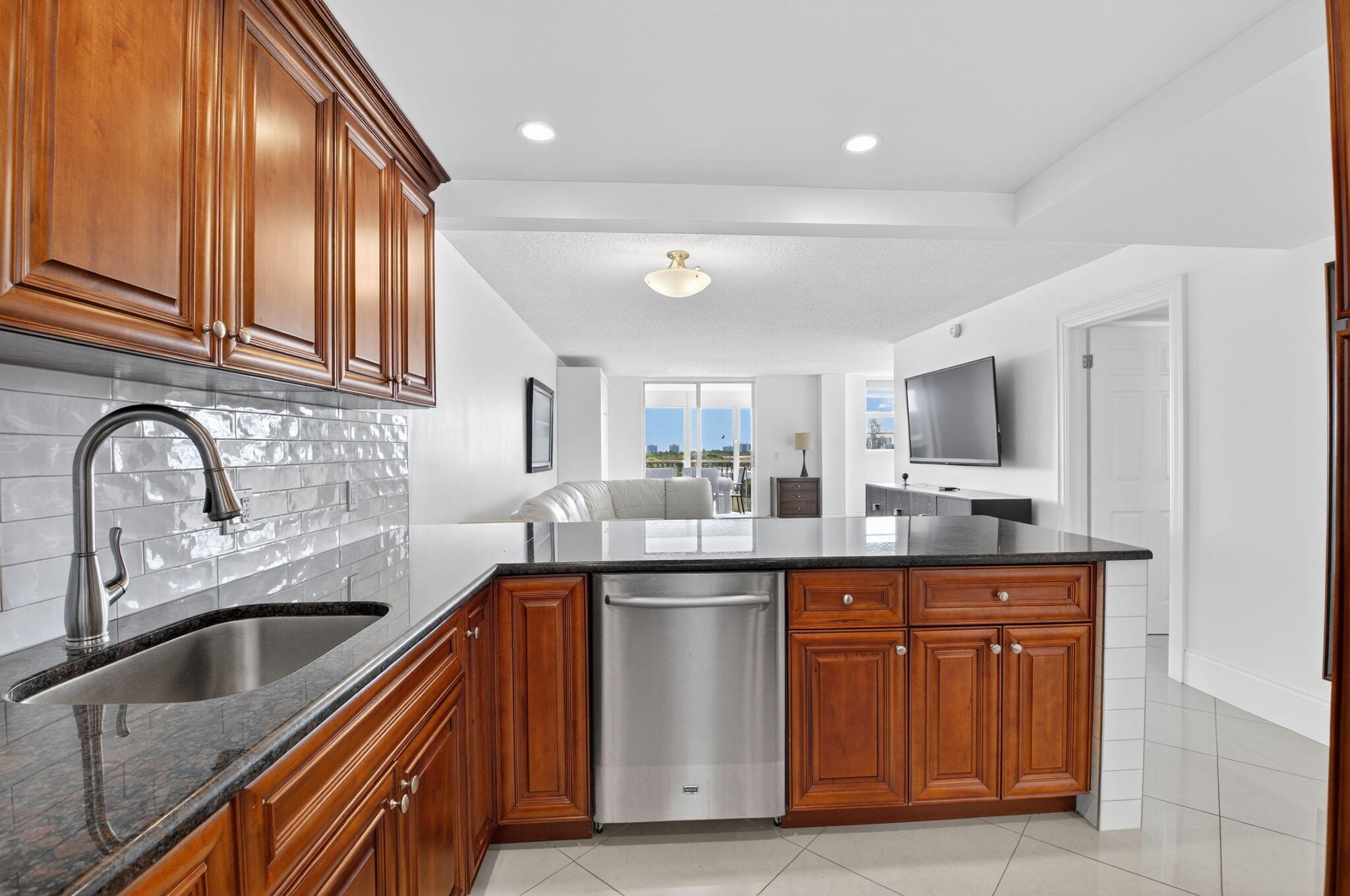 5500 Northwest 2nd Avenue, Unit 718 Boca Raton, FL 33487 - Photo 9 of 34 a kitchen with stainless steel appliances granite countertop a sink and cabinets