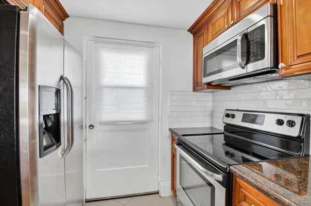 a kitchen with stainless steel appliances a stove a microwave and a refrigerator