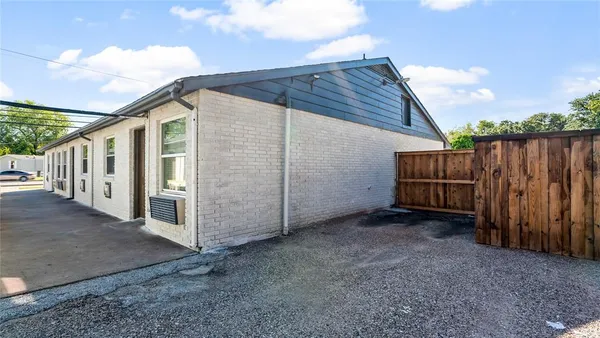 a view of a house with wooden fence