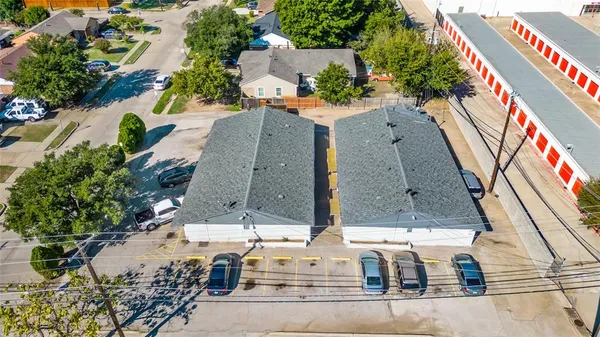 an aerial view of residential houses with outdoor space