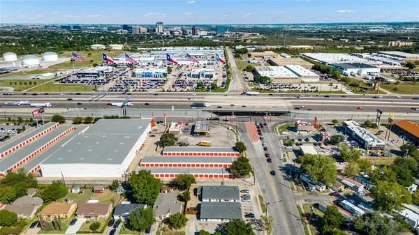 a living room with stainless steel appliances furniture and a wooden floor