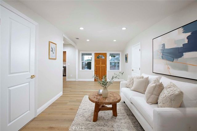 a bathroom with a granite countertop sink a toilet and mirror