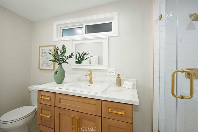 a bathroom with a shower sink and mirror