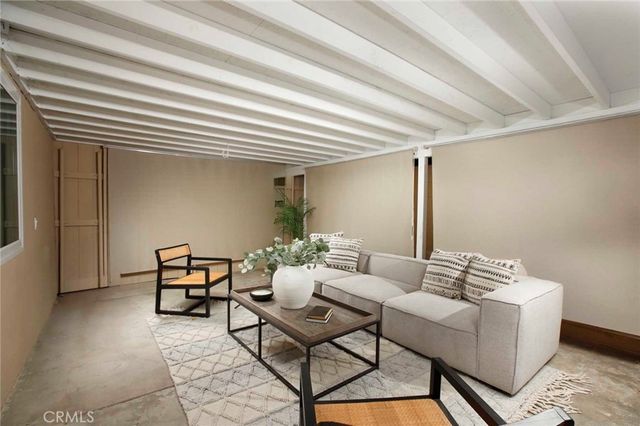 a view of a patio with couple of chairs and a fountain