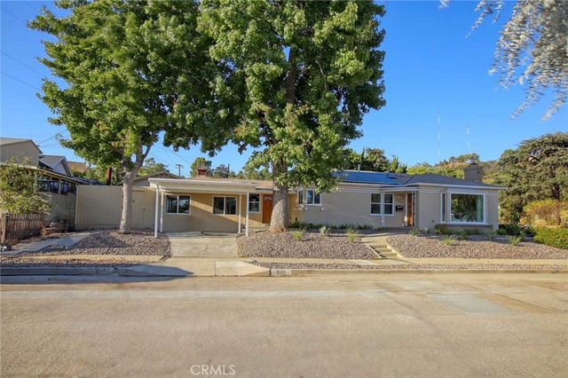 a house with trees in the background