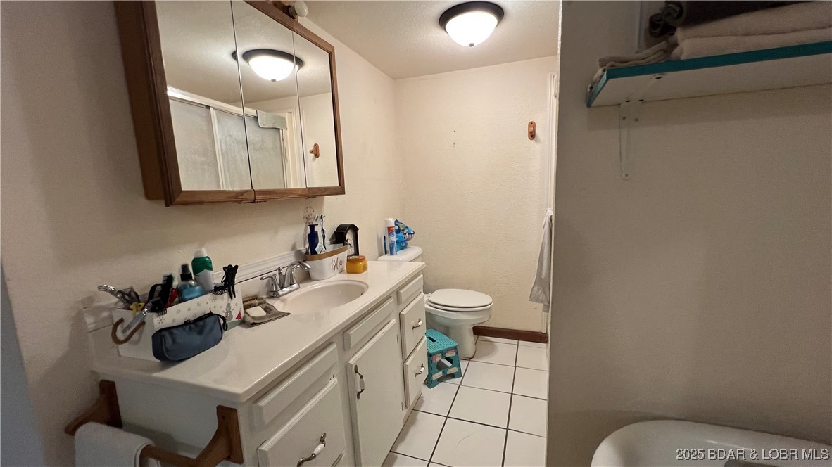 134 West 8th Street Eldon, MO 65026 - Photo 12 of 49 Full bathroom with a walk in shower and soaker tub