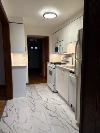 a kitchen with stainless steel appliances granite countertop a sink and cabinets