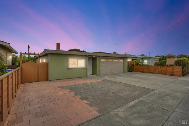 a view of a house with a yard and a garage