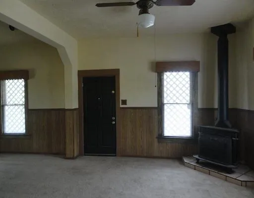an empty room with windows and closet