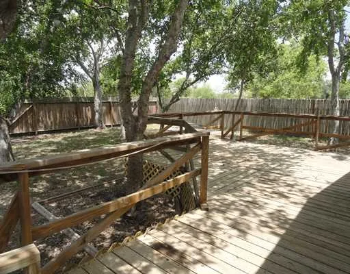 a view of a yard with wooden fence