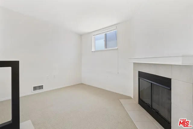 a view of an empty room with a fireplace