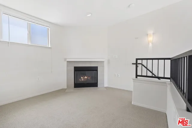 a view of an empty room with a fireplace