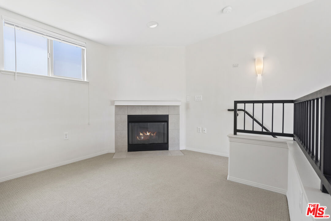 100 South Alameda Street, Unit 418 Los Angeles, CA 90012 - Photo 20 of 32 a view of an empty room with a fireplace