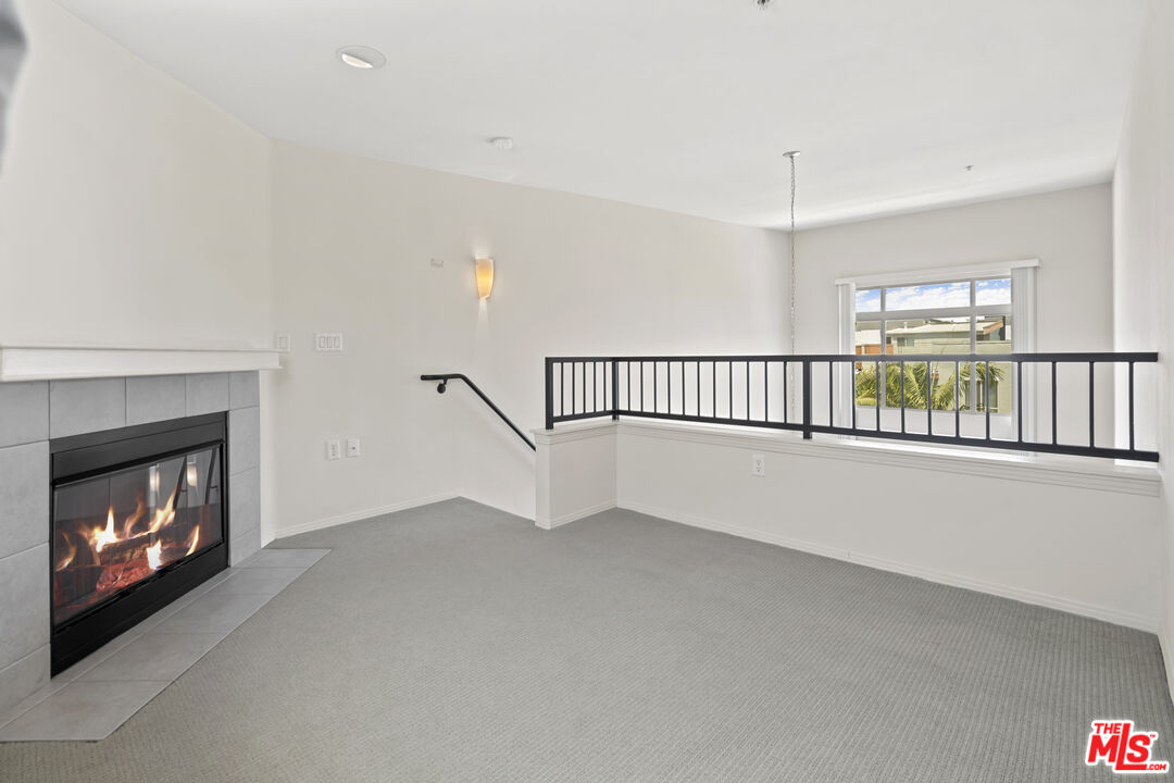 100 South Alameda Street, Unit 418 Los Angeles, CA 90012 - Photo 21 of 32 a view of an empty room with a fireplace