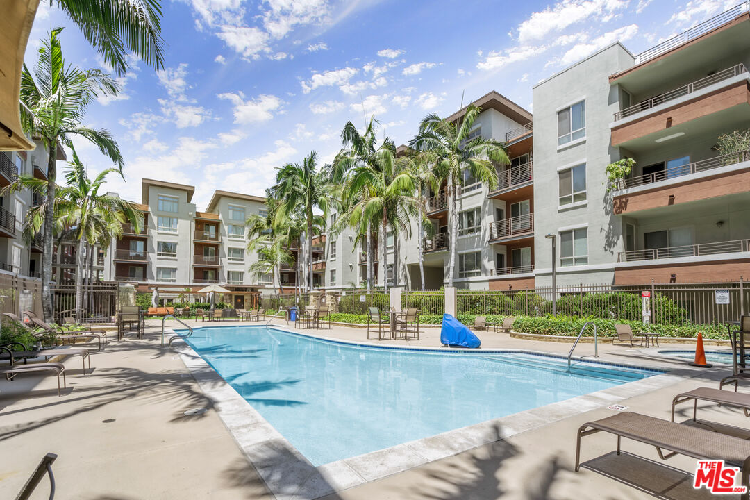 100 South Alameda Street, Unit 418 Los Angeles, CA 90012 - Photo 22 of 32 a view of a swimming pool with a lounge chairs