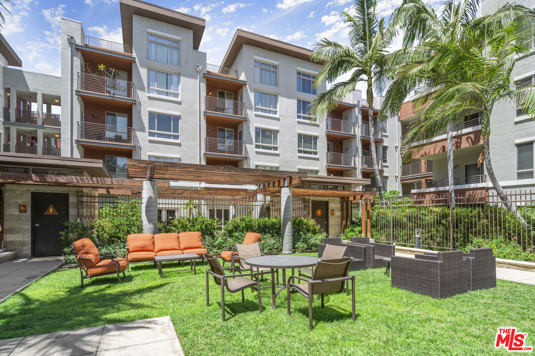 100 South Alameda Street, Unit 418 Los Angeles, CA 90012 - Photo 25 of 32 a view of a building with a yard and sitting area