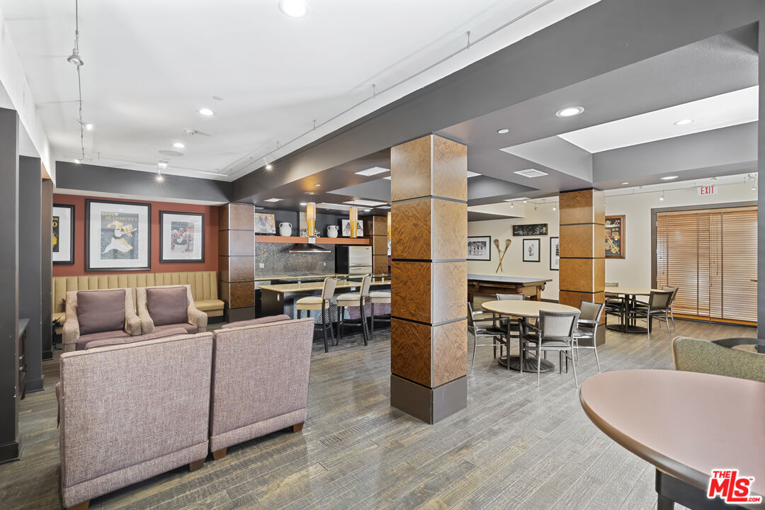 100 South Alameda Street, Unit 418 Los Angeles, CA 90012 - Photo 28 of 32 a living room with furniture kitchen view and a wooden floor