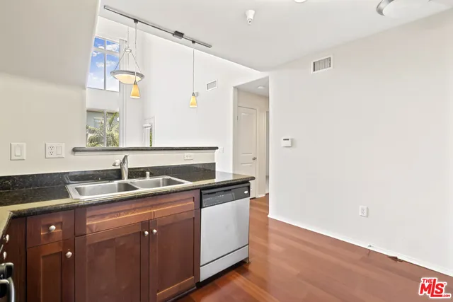 a utility room with cabinets washer and dryer