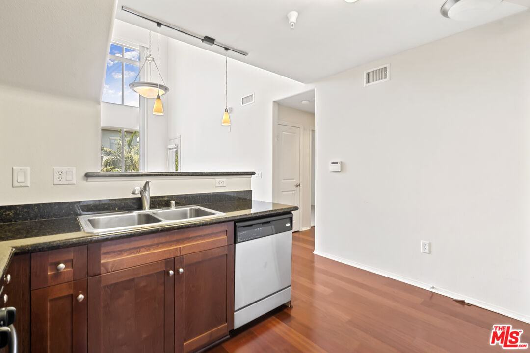 100 South Alameda Street, Unit 418 Los Angeles, CA 90012 - Photo 4 of 32 a utility room with cabinets washer and dryer
