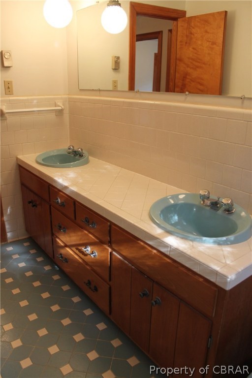 7449 Joseph Lewis Road Hayes, VA 23072 - Photo 30 of 32 Hall bath with double sink tile vanity.