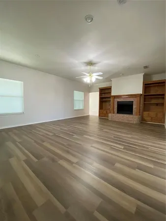 a view of a livingroom with an empty space and a fireplace