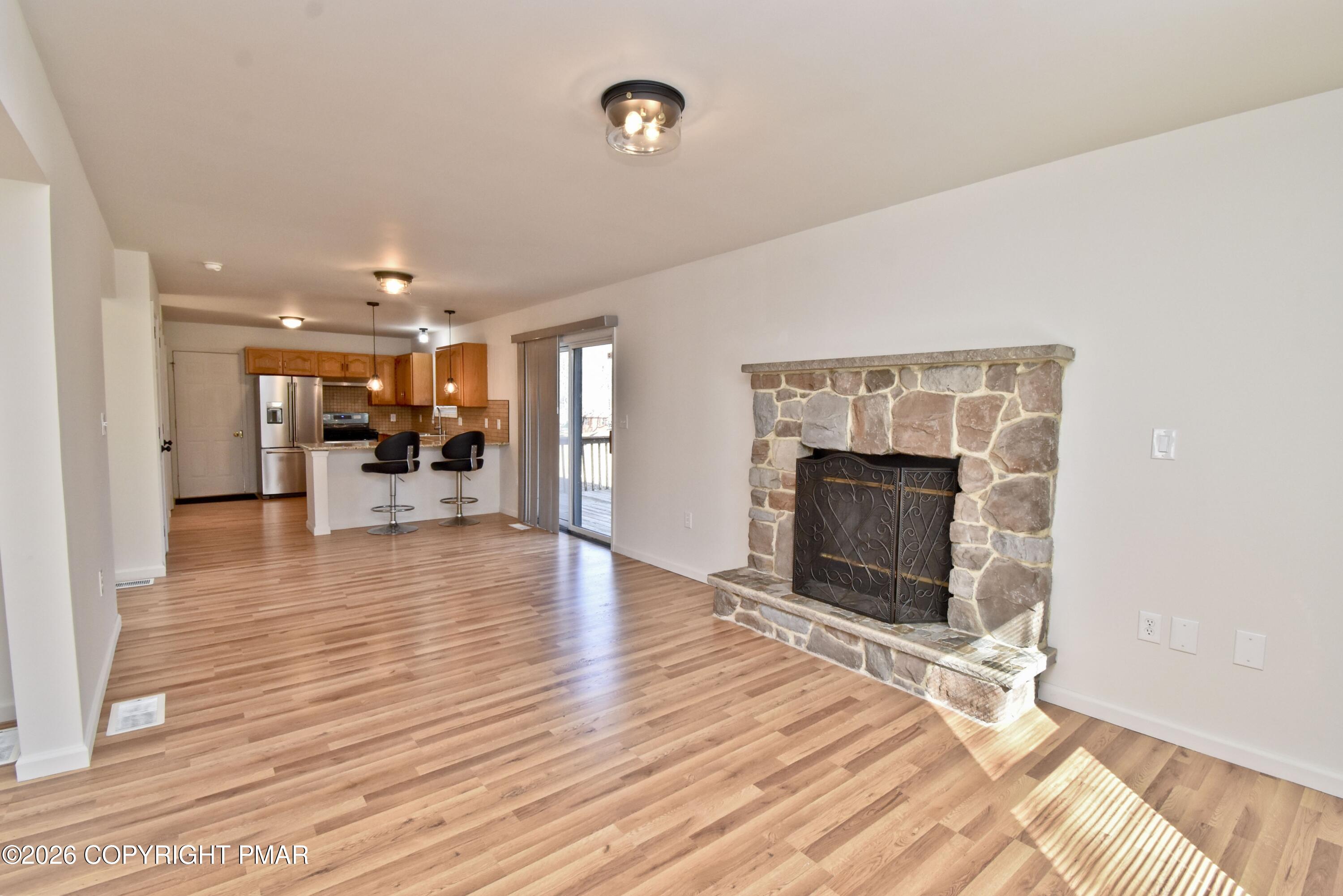 108 Pipher Road Bushkill, PA 18324 - Photo 11 of 50 a view of a livingroom with wooden floor and a fireplace