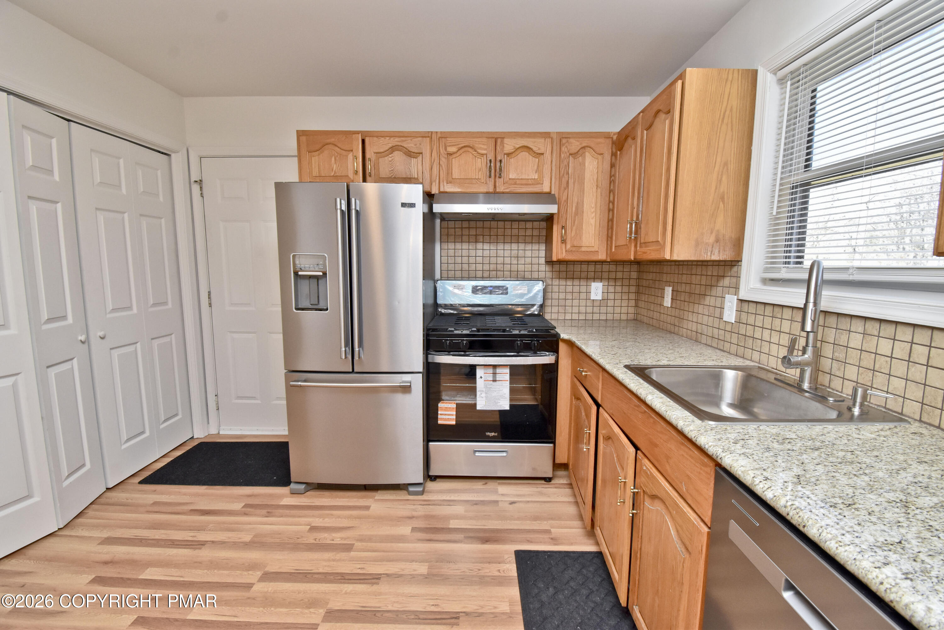 108 Pipher Road Bushkill, PA 18324 - Photo 13 of 50 a kitchen with granite countertop stainless steel appliances a refrigerator sink and microwave
