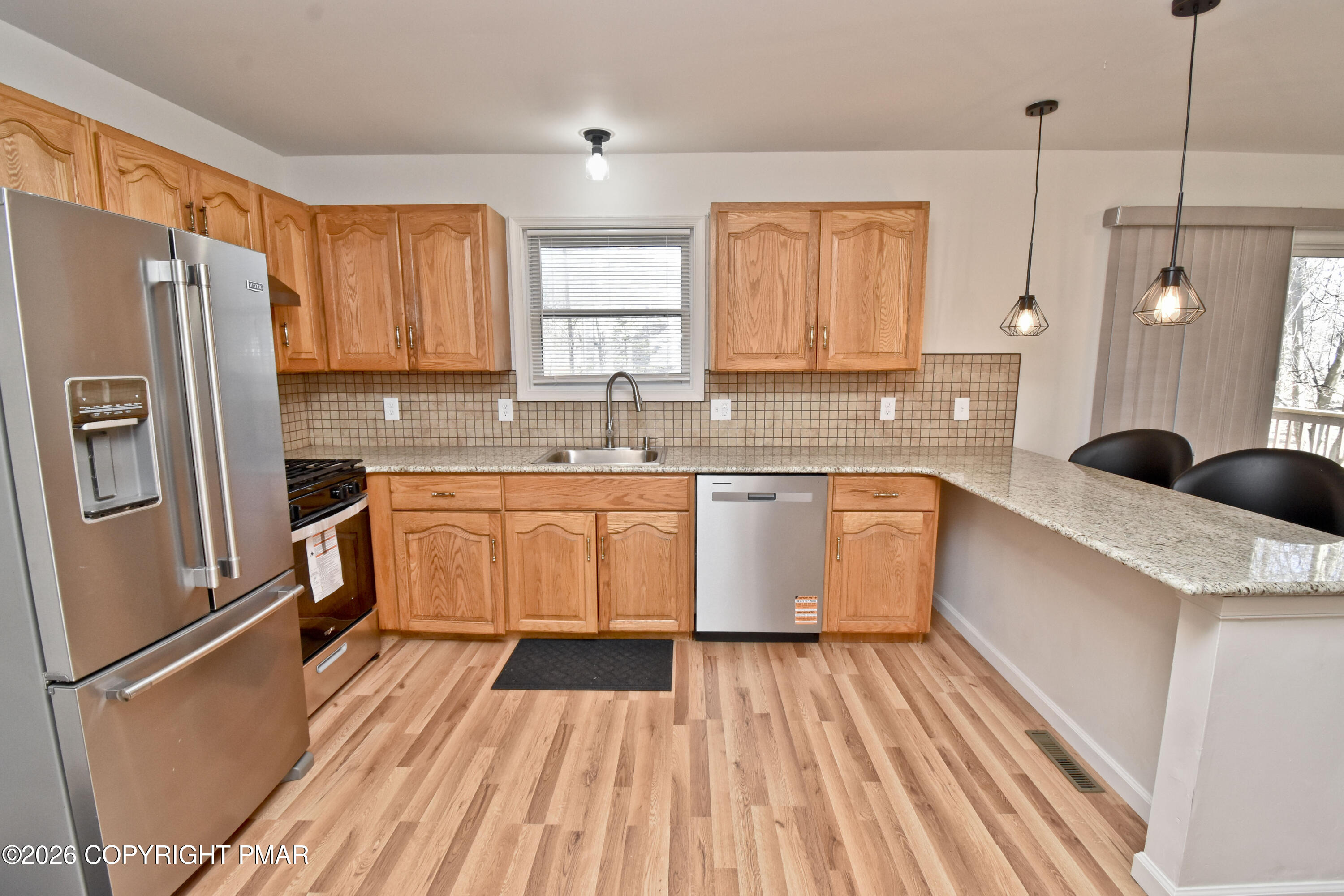 108 Pipher Road Bushkill, PA 18324 - Photo 15 of 50 a large kitchen with a sink refrigerator and cabinets