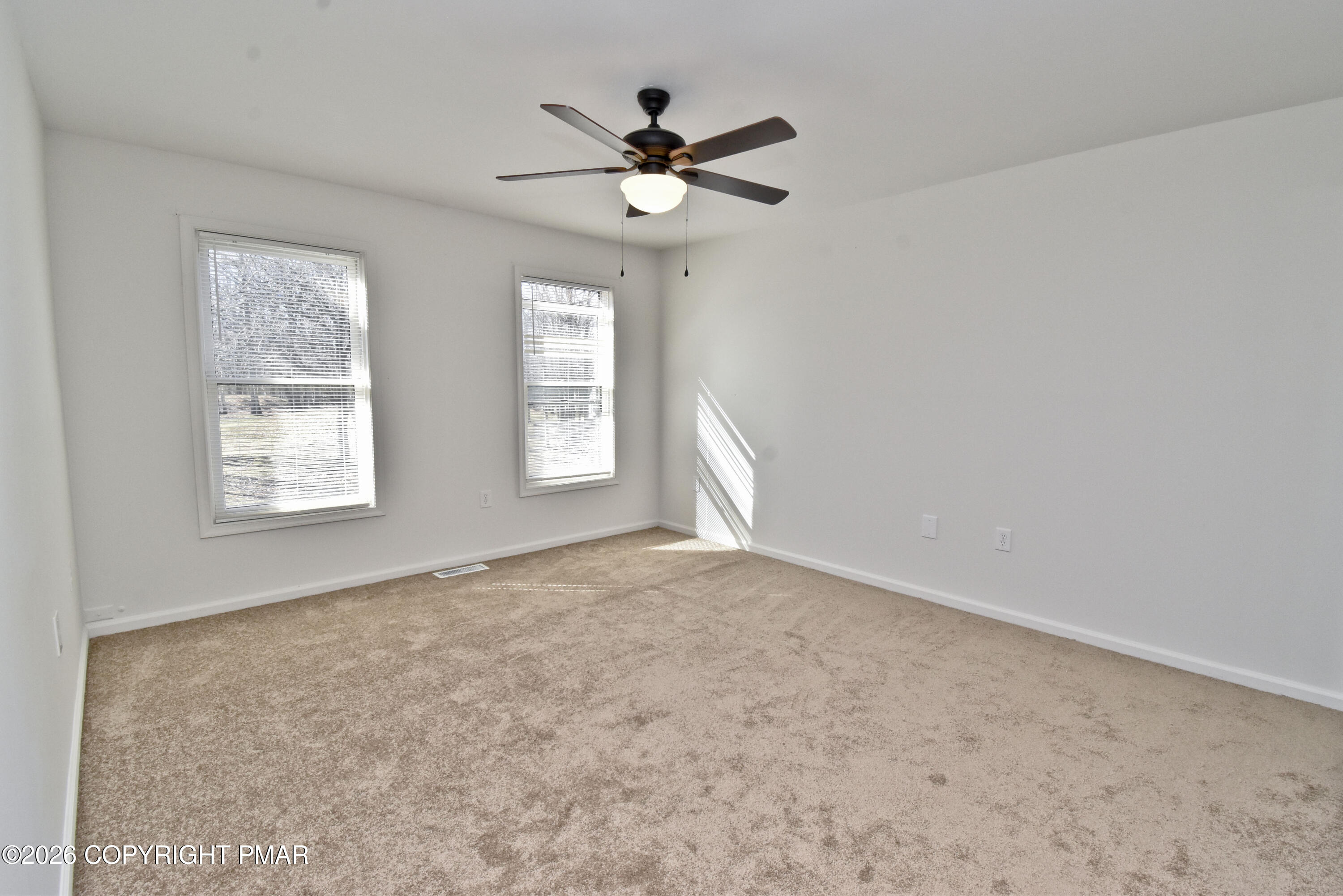 108 Pipher Road Bushkill, PA 18324 - Photo 24 of 50 an empty room with windows and ceiling fan