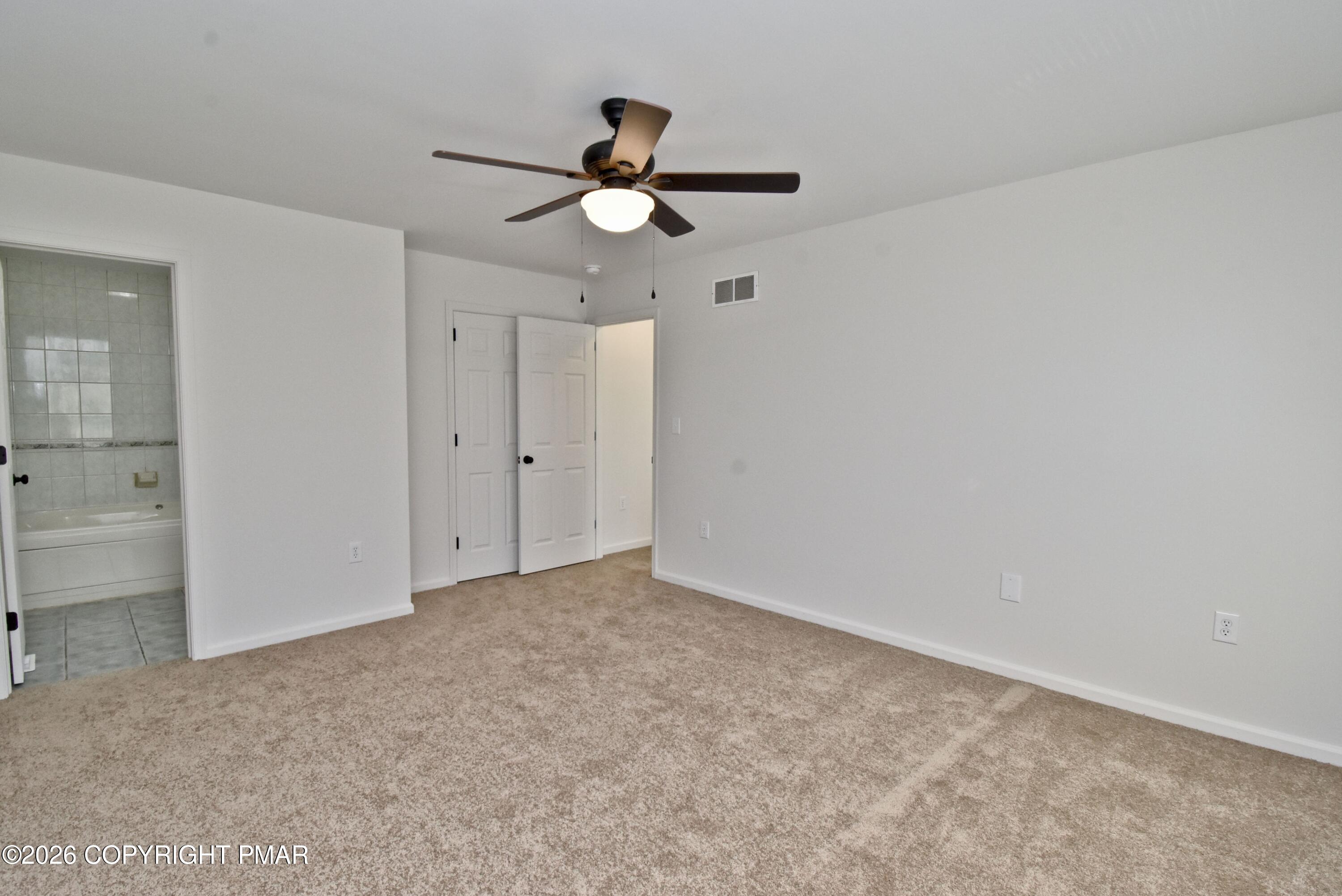 108 Pipher Road Bushkill, PA 18324 - Photo 26 of 50 an empty room with closet and a chandelier fan