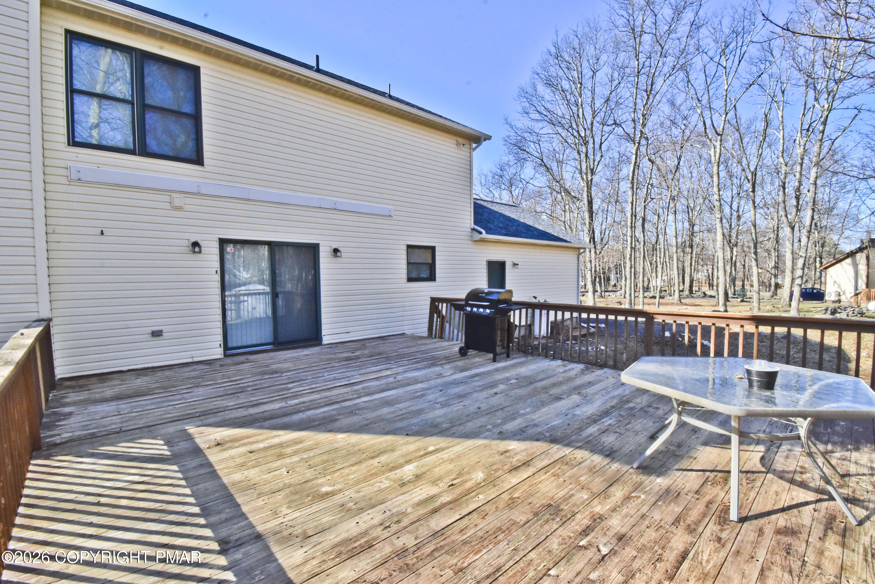108 Pipher Road Bushkill, PA 18324 - Photo 35 of 50 a view of a roof deck with table and chairs with wooden floor and fence