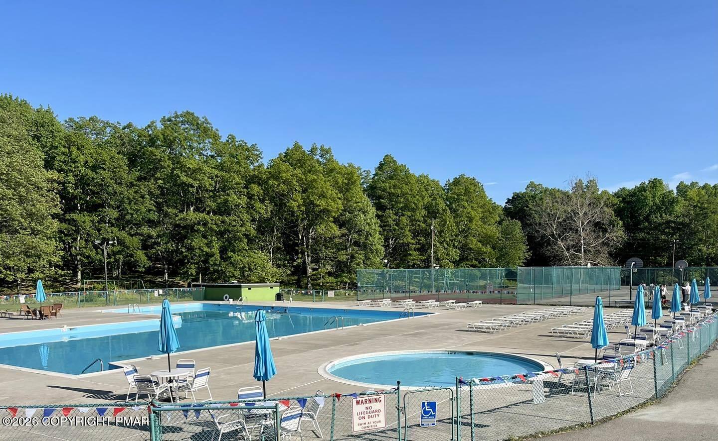 108 Pipher Road Bushkill, PA 18324 - Photo 47 of 50 a view of a swimming pool with an outdoor seating and a yard