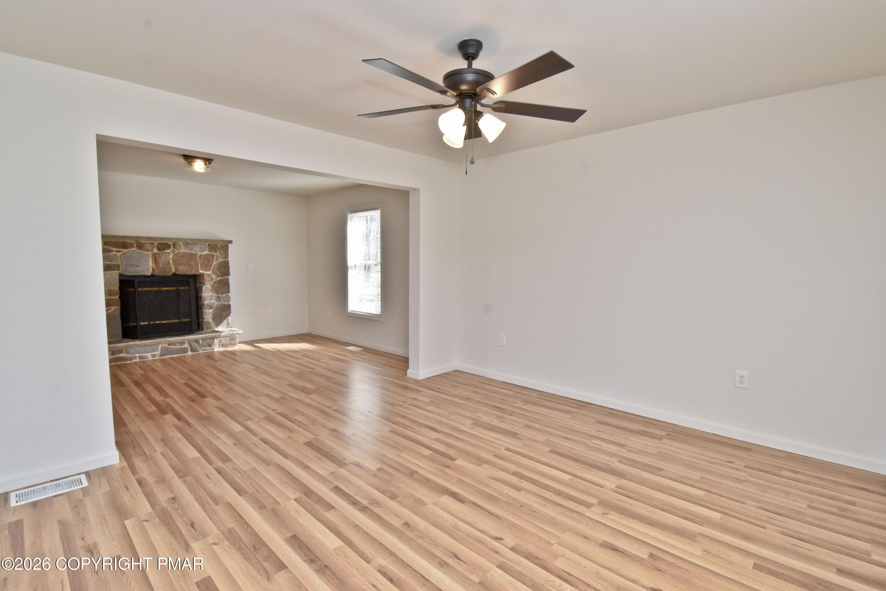 108 Pipher Road Bushkill, PA 18324 - Photo 7 of 50 an empty room with wooden floor fan and windows