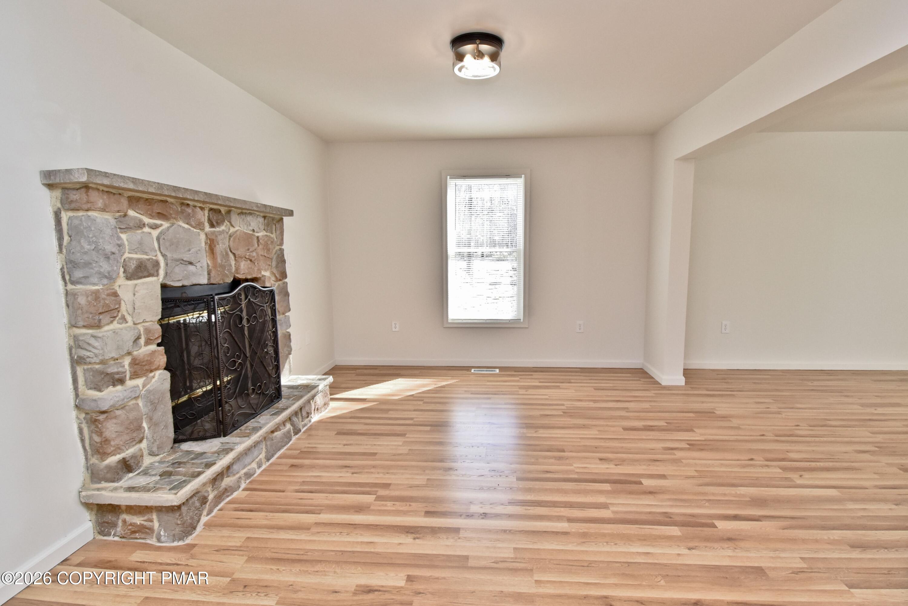 108 Pipher Road Bushkill, PA 18324 - Photo 8 of 50 a view of a livingroom with wooden floor and a window