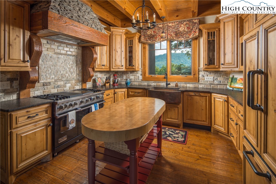 5212 Reynolds Parkway Boone, NC 28607 - Photo 12 of 50 a kitchen with granite countertop a sink a counter space appliances and cabinets