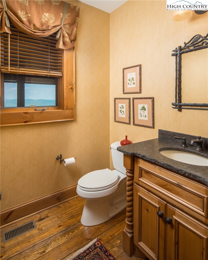 5212 Reynolds Parkway Boone, NC 28607 - Photo 13 of 50 a bathroom with a toilet a sink and mirror