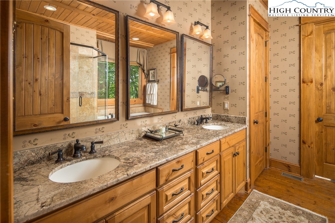 5212 Reynolds Parkway Boone, NC 28607 - Photo 16 of 50 a bathroom with a granite countertop double vanity sink and a mirror