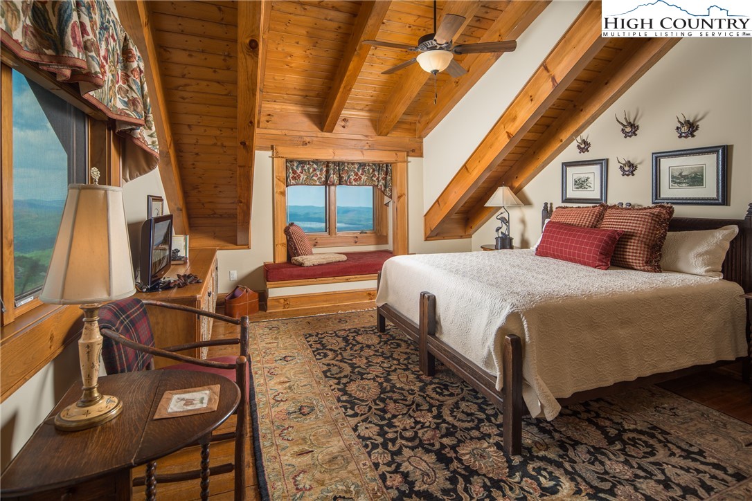 5212 Reynolds Parkway Boone, NC 28607 - Photo 24 of 50 a bedroom with a bed and wooden floor