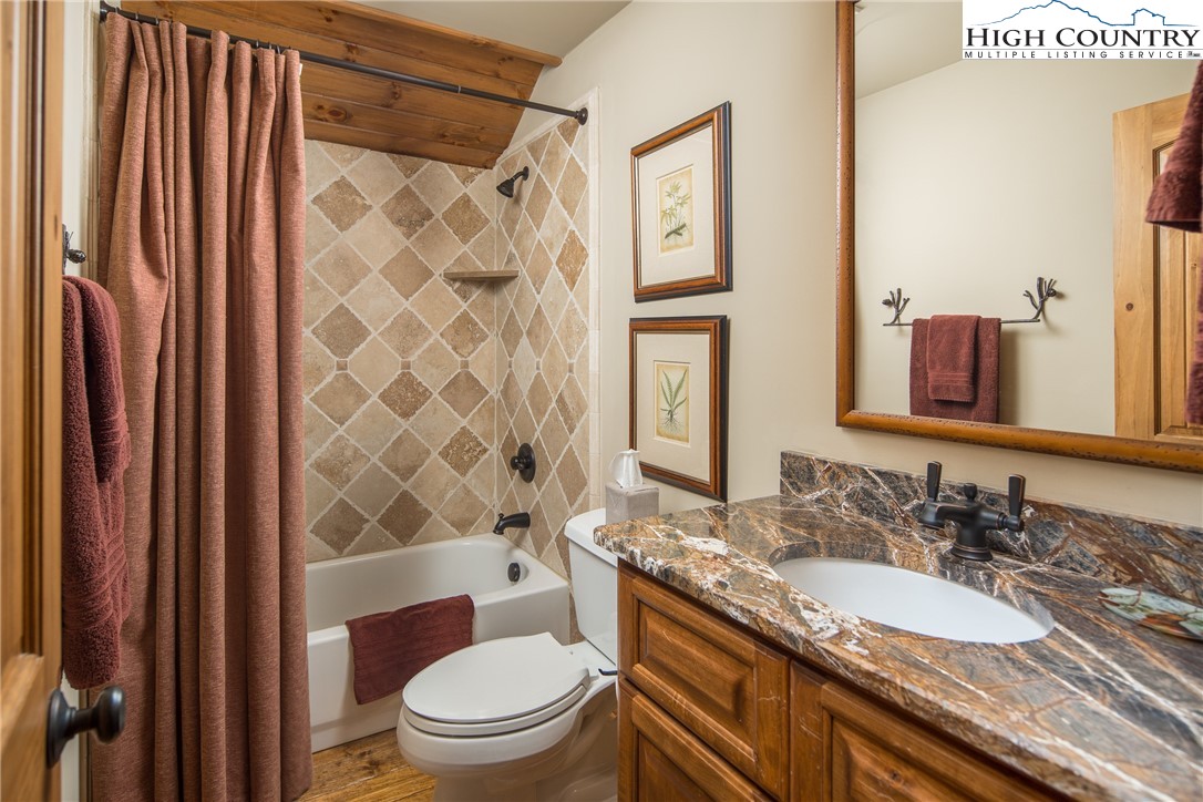 5212 Reynolds Parkway Boone, NC 28607 - Photo 25 of 50 a bathroom with a granite countertop toilet sink and mirror