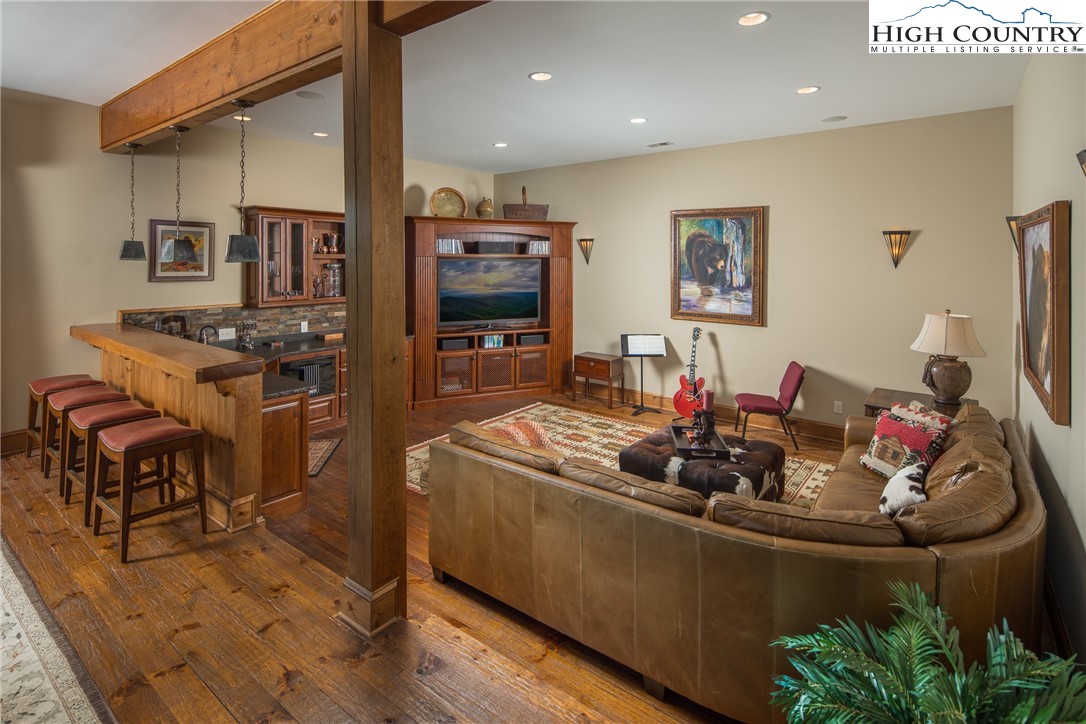 5212 Reynolds Parkway Boone, NC 28607 - Photo 32 of 50 a living room with stainless steel appliances furniture a rug and a kitchen view
