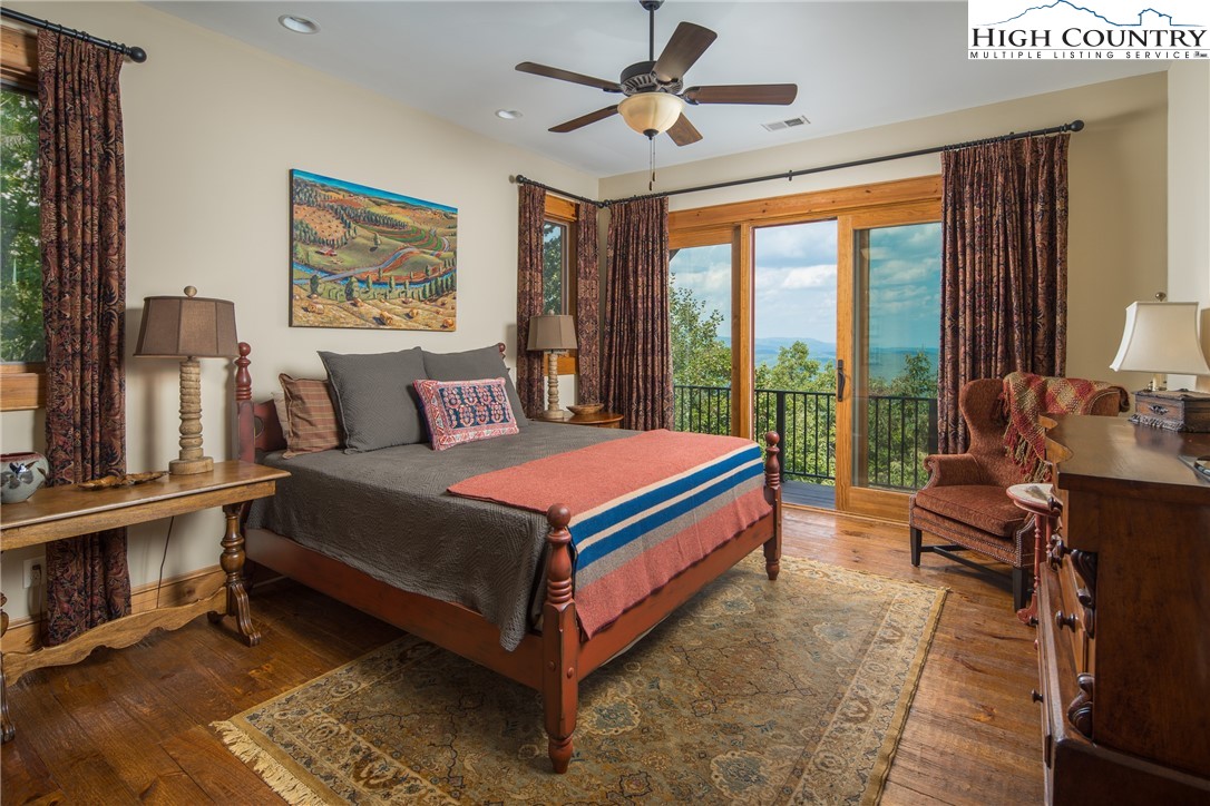 5212 Reynolds Parkway Boone, NC 28607 - Photo 37 of 50 a bedroom with a bed and a chandelier