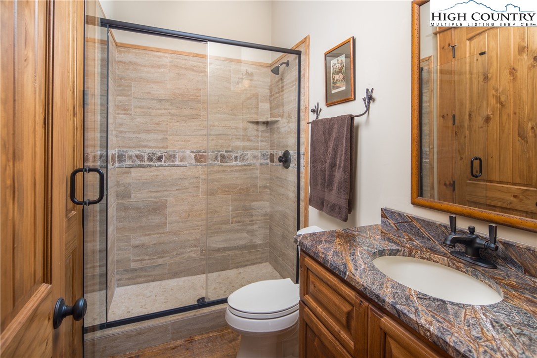 5212 Reynolds Parkway Boone, NC 28607 - Photo 39 of 50 a bathroom with a granite countertop sink toilet and shower