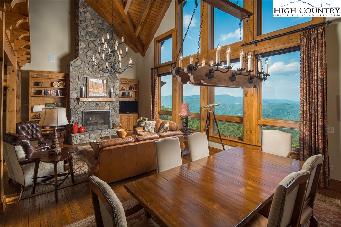 5212 Reynolds Parkway Boone, NC 28607 - Photo 6 of 50 a view of a dining room with furniture a chandelier and wooden floor