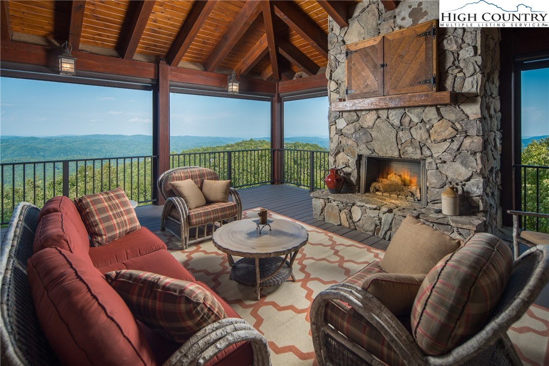 5212 Reynolds Parkway Boone, NC 28607 - Photo 9 of 50 a outdoor living space with furniture a fireplace and a floor to ceiling window