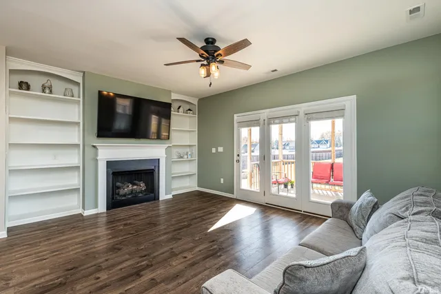 a living room with furniture fireplace and flat screen tv