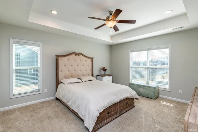 a bedroom with a large bed and a window