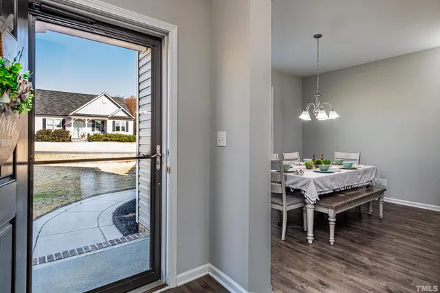 a dining room with a wooden table and chairs